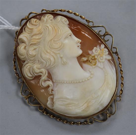 A large cameo brooch carved with the head of a maiden, in 9ct gold openwork mount